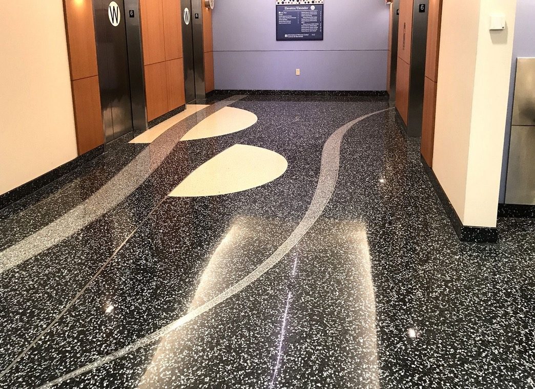 Glossy terrazzo floor in a building lobby maintained with SIMIX Multi-Surface Ceramic Clearcoat