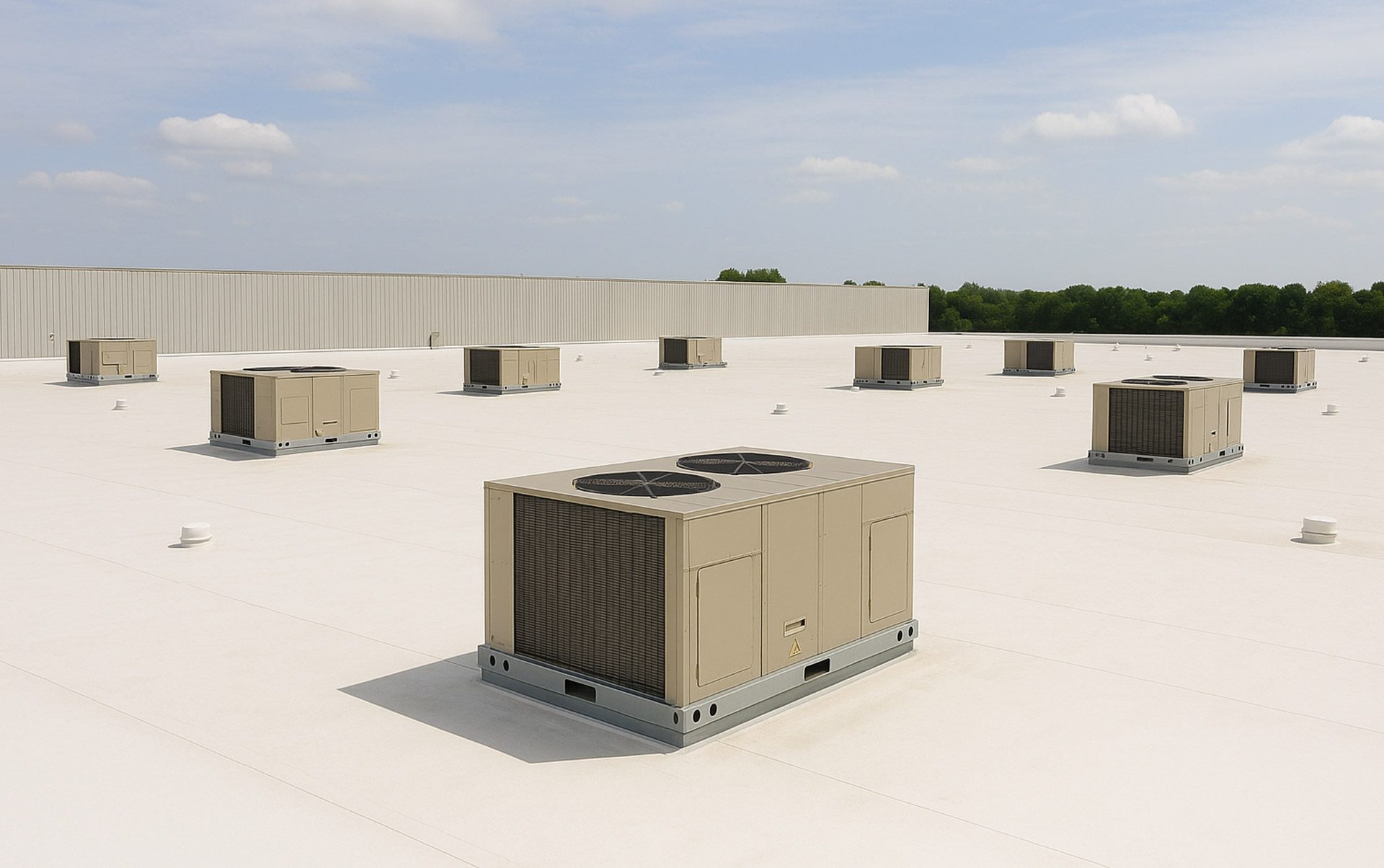 Packaged rooftop HVAC unit on a clean white membrane commercial roof