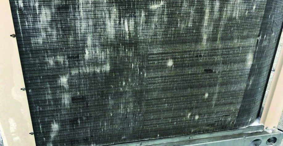 Fouled, weathered condenser coil on the 15-year-old Waffle House #265 rooftop unit before cleaning and coating